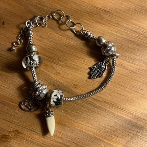 Charm bracelet adjustable silver with lotus flower charm, saber tooth charm
